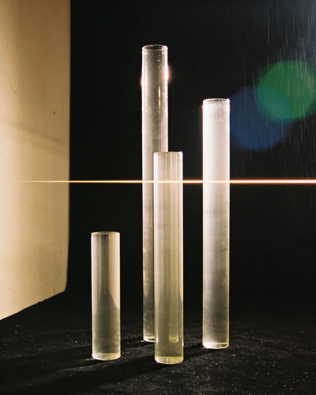 Glass columns of different heights with a glowing limit line