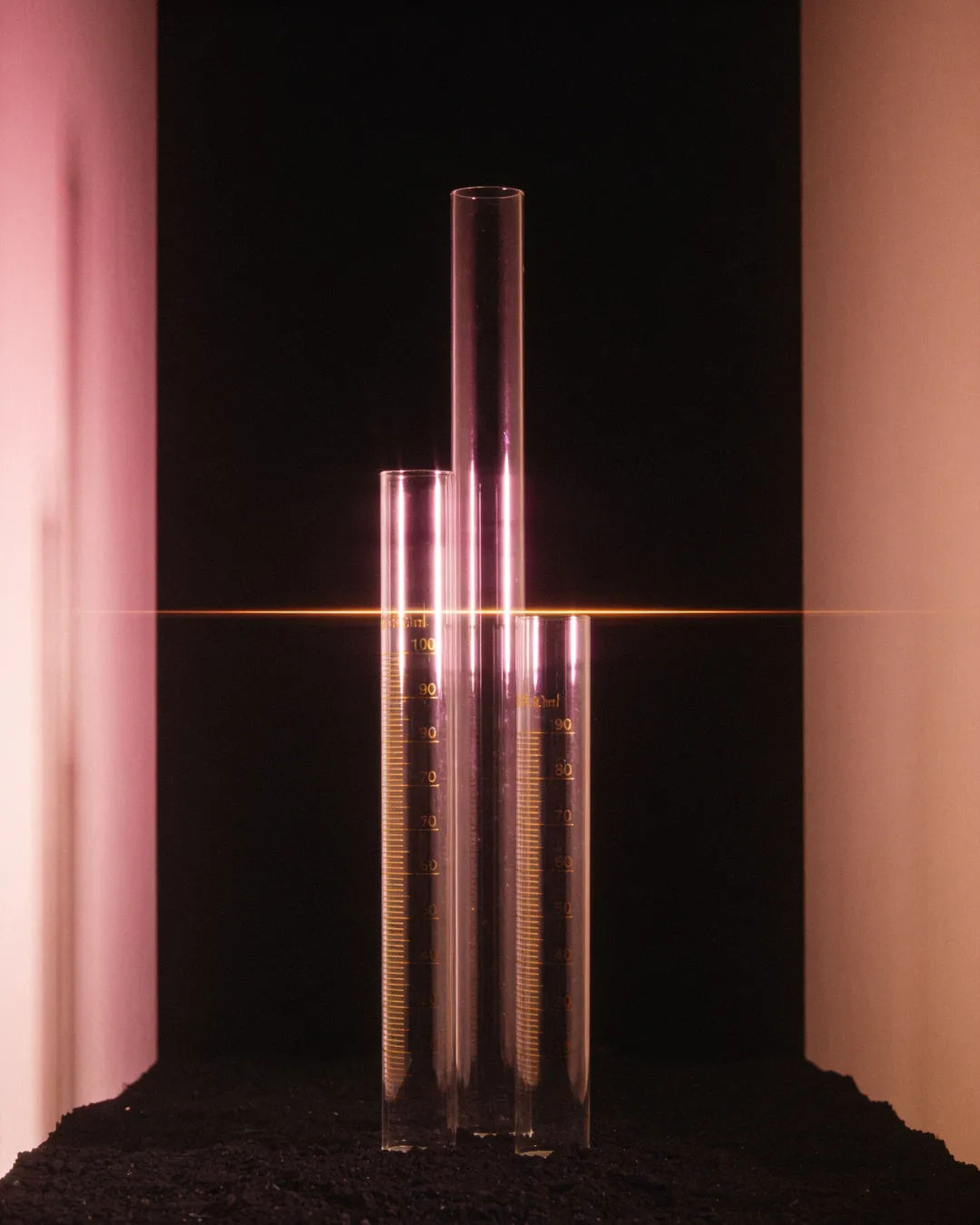 Glass columns of different heights with a glowing limit line