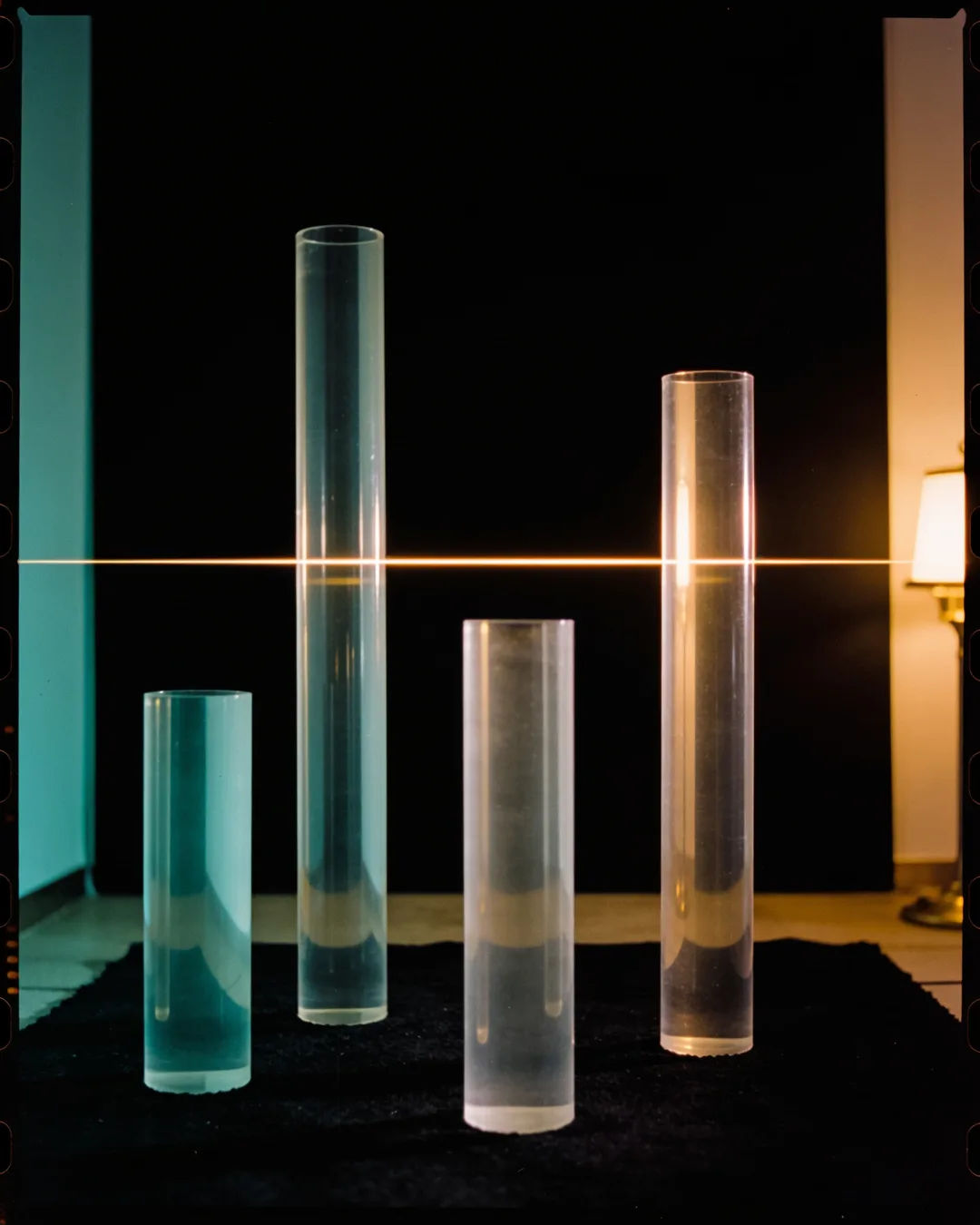 Glass columns of different heights with a glowing limit line