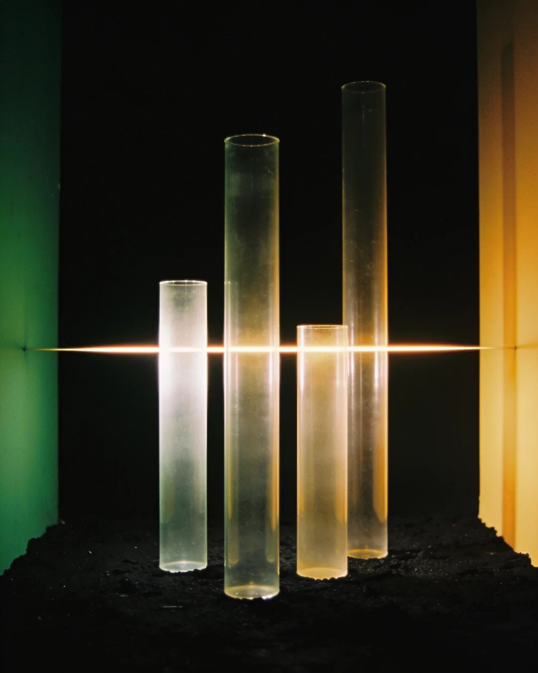 Glass columns of different heights with a glowing limit line