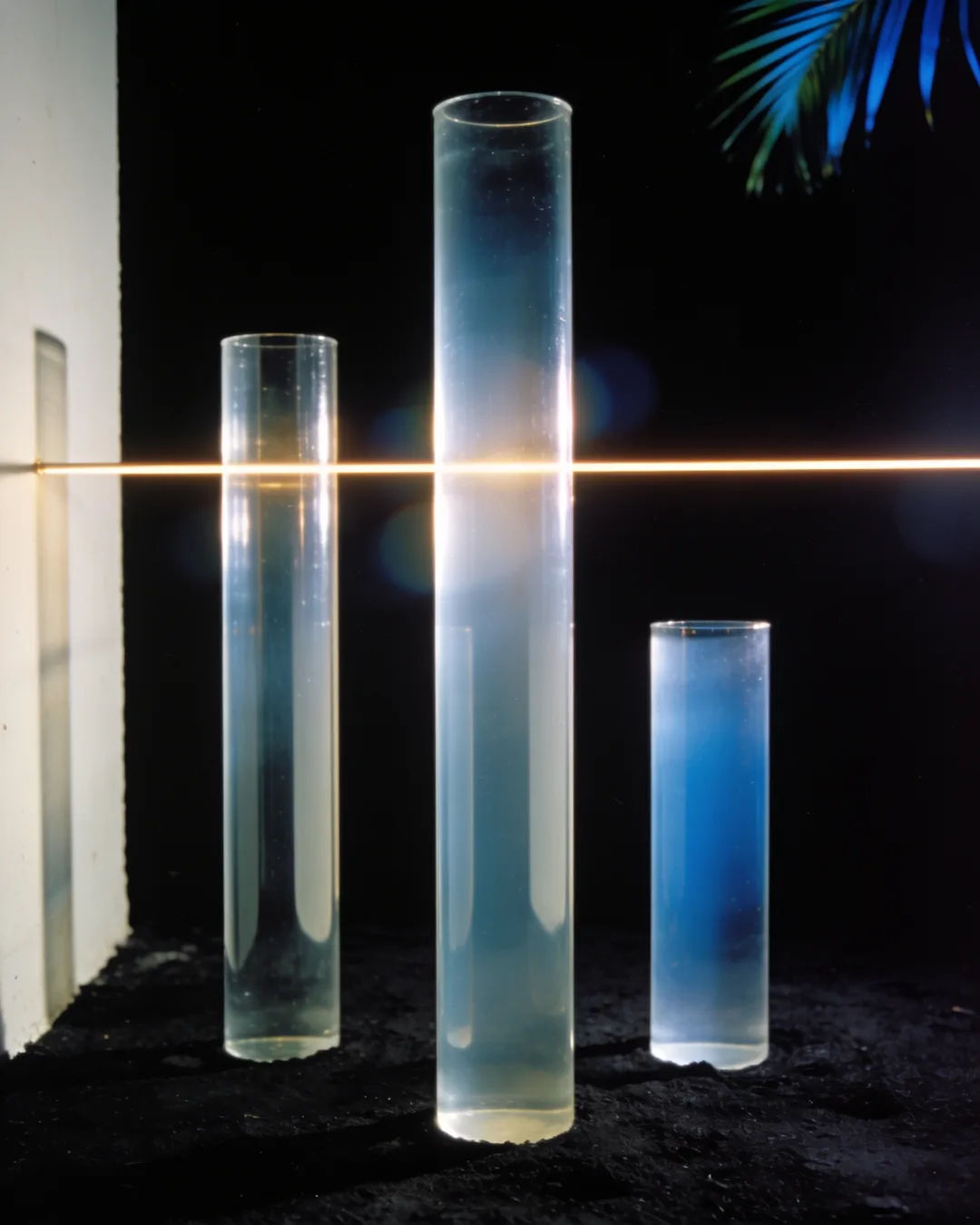 Glass columns of different heights with a glowing limit line