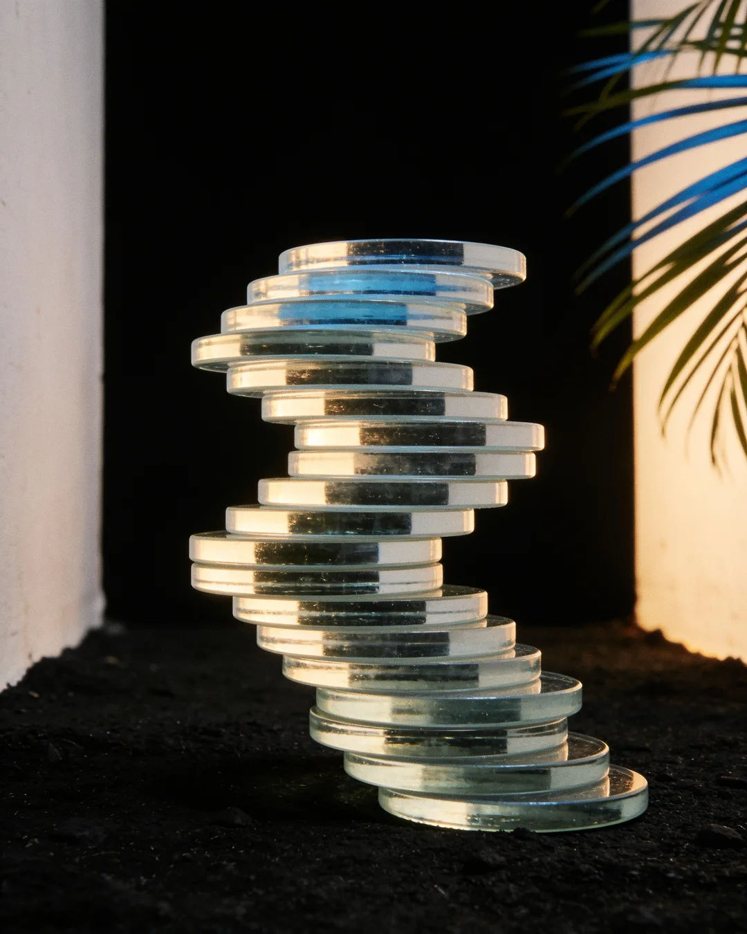 Stacks of glass tokens rising on a black ground