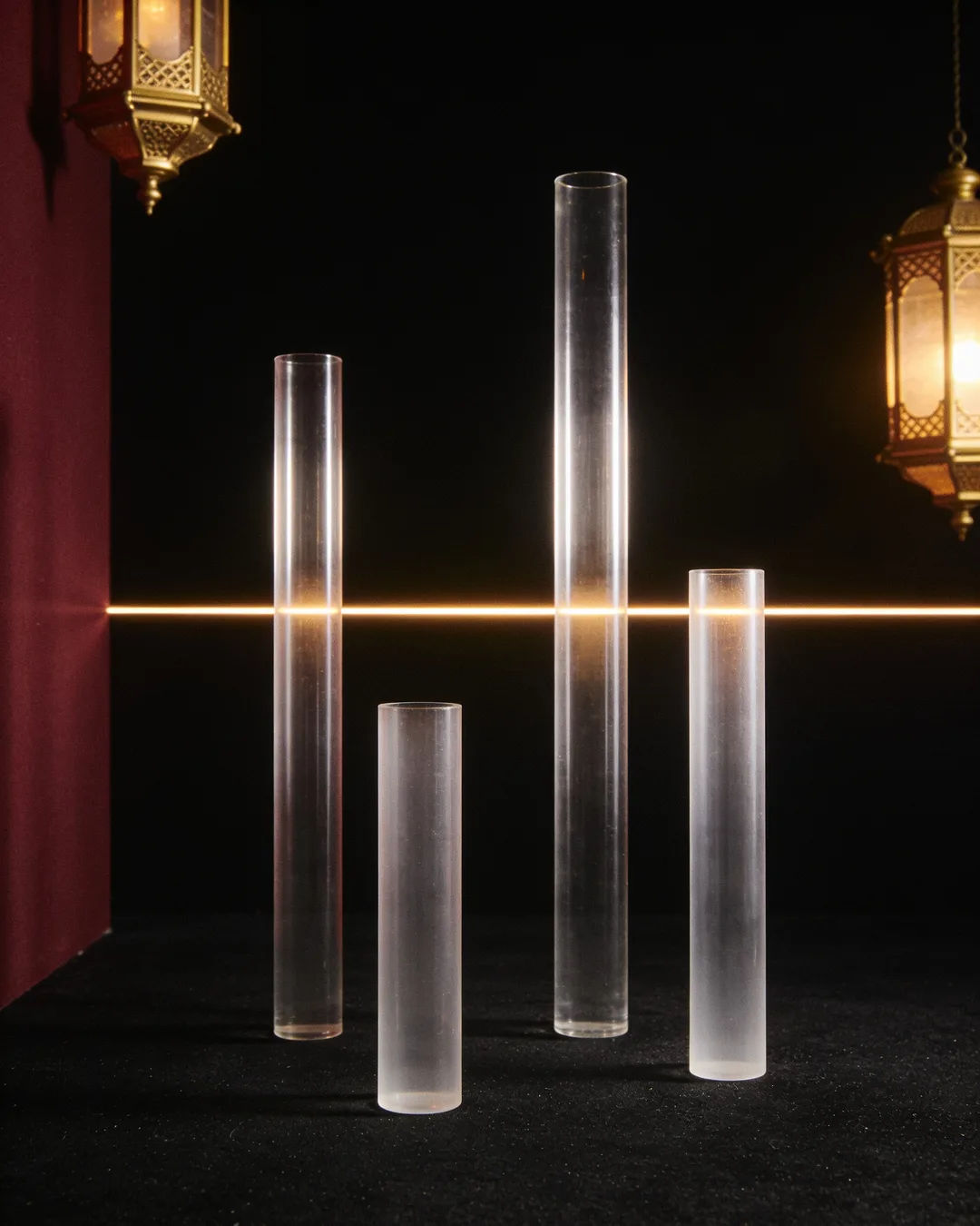 Glass columns of different heights with a glowing limit line