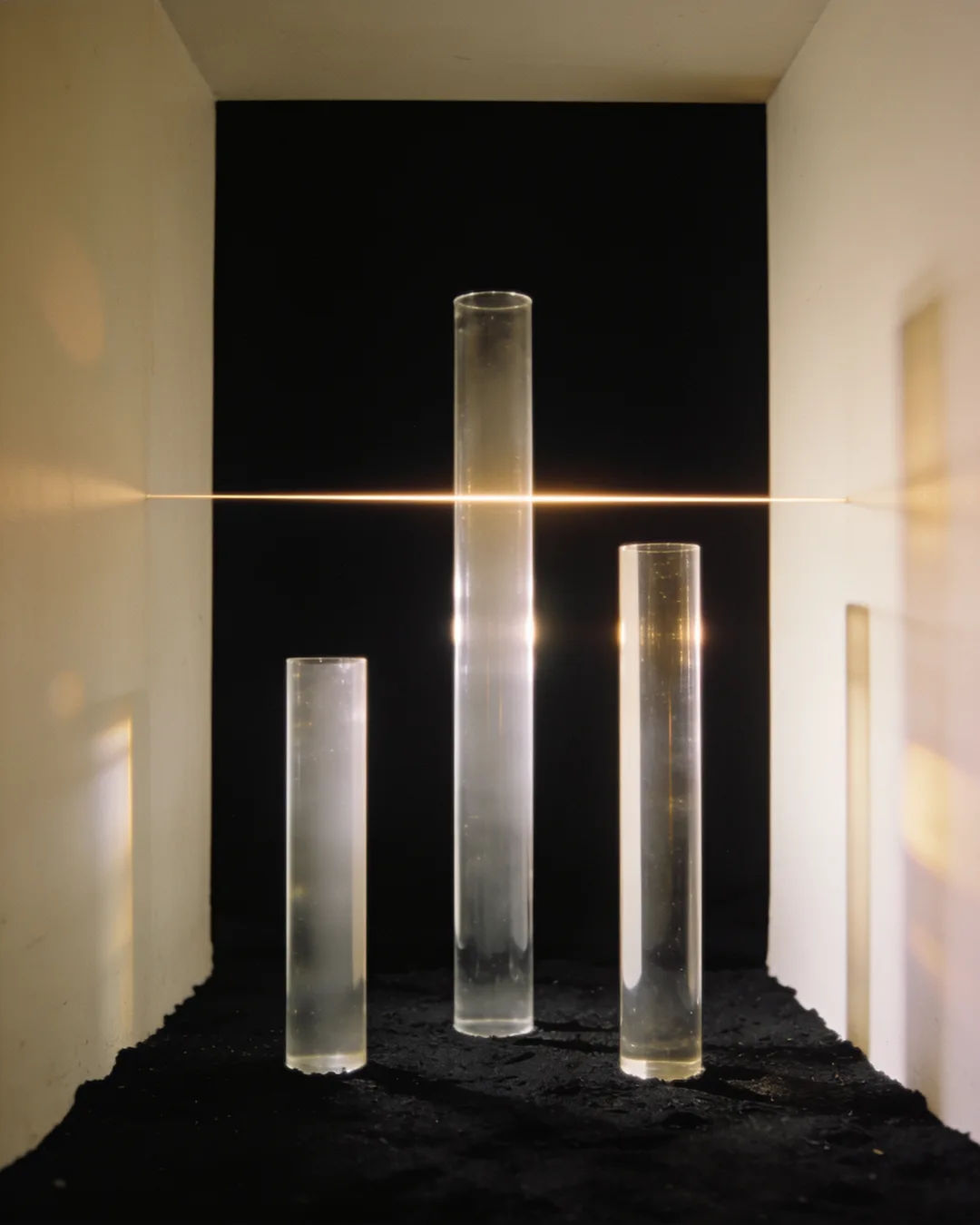Glass columns of different heights with a glowing limit line