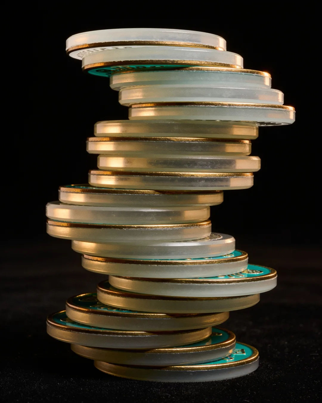 Stacks of glass tokens rising on a black ground