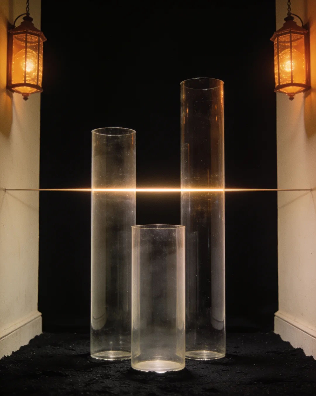 Glass columns of different heights with a glowing limit line
