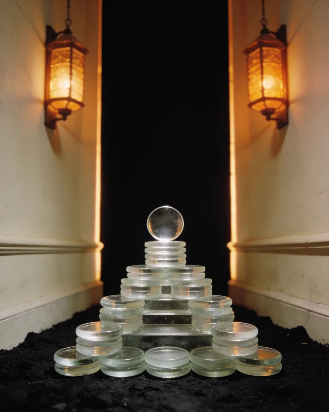 Stacks of glass tokens rising on a black ground
