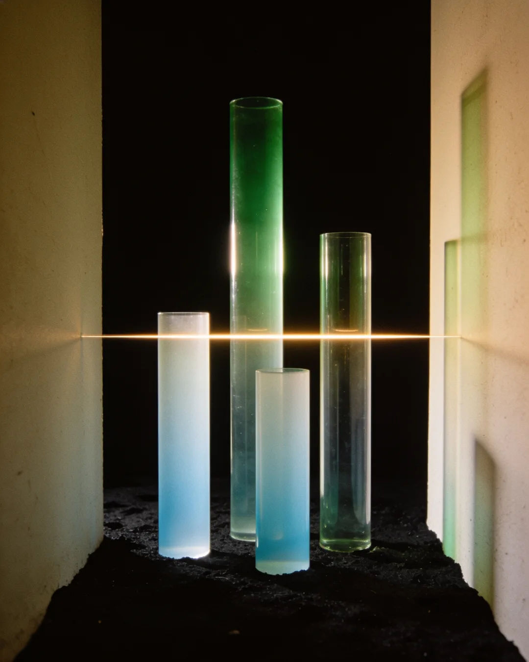 Glass columns of different heights with a glowing limit line