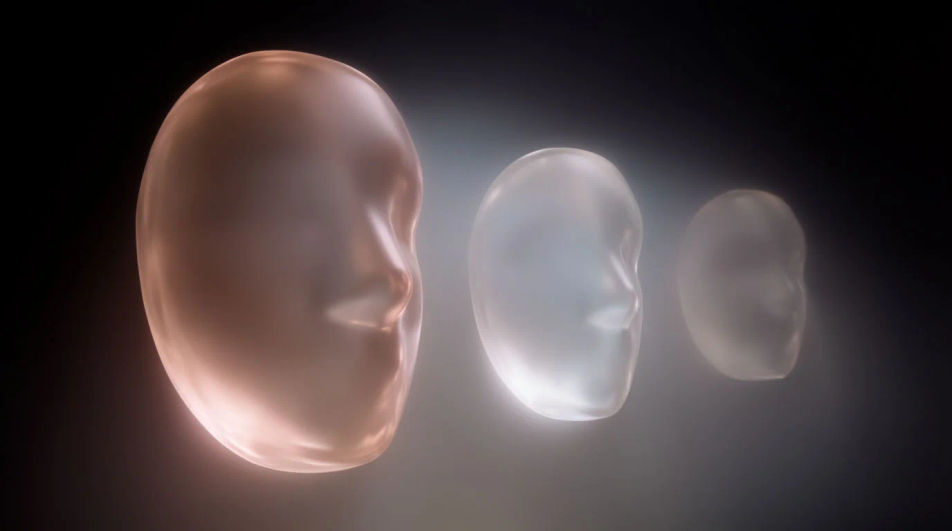 Three translucent glass masks floating in haze, each lit from a different side