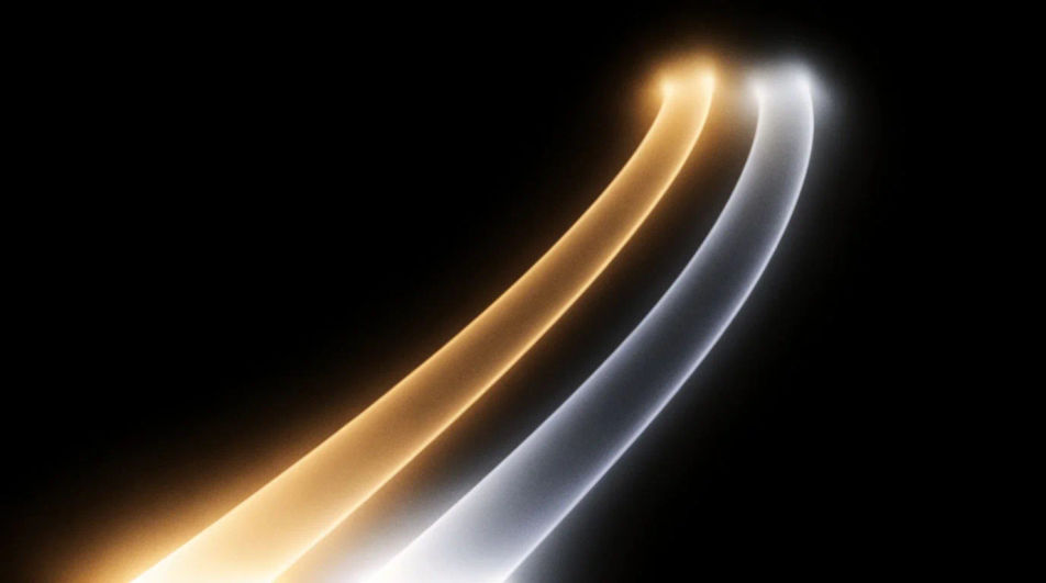 Two ribbons of light, one amber and one cool silver, answering each other across the dark