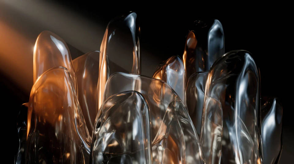 Several translucent glass forms gathered in haze, each catching light from another