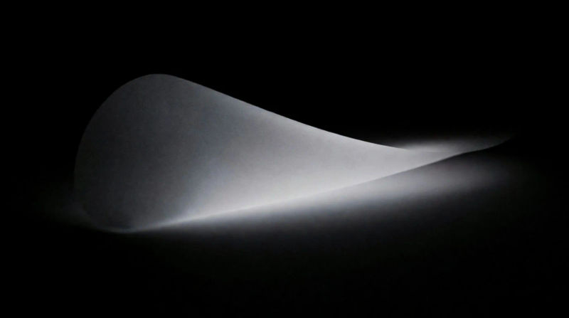 A gentle fold of bone-white light catching along its crease
