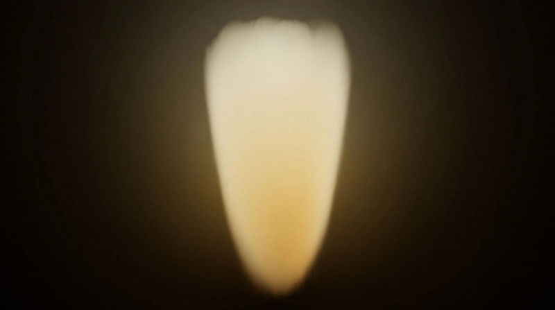 A slow taper of soft amber light narrowing to a point