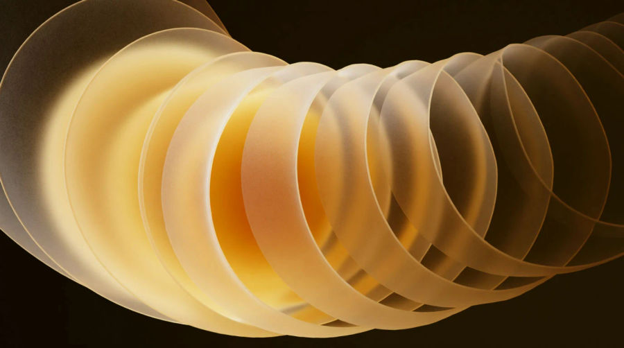 A long slow spiral of amber light receding into depth with even turns