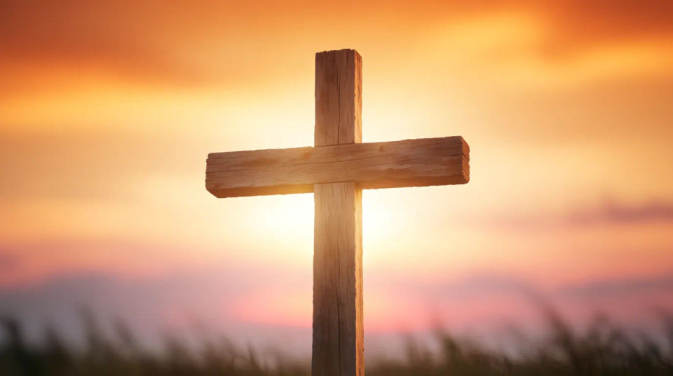 Cross against sunset