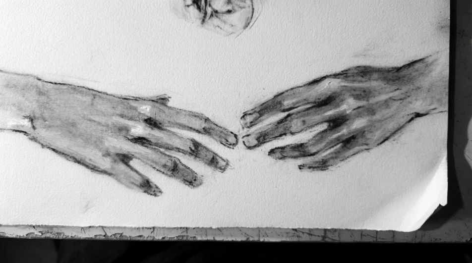 Two hands reaching toward each other