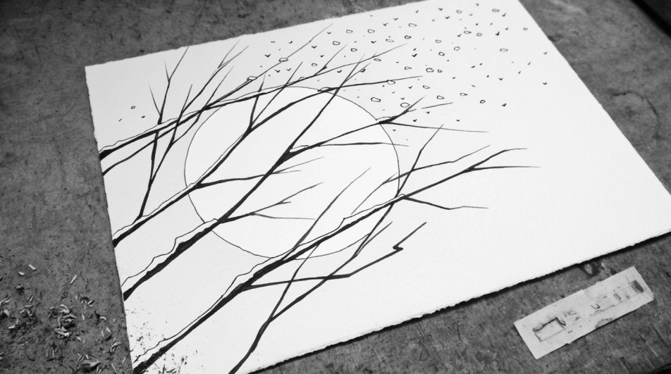 Moon behind bare branches