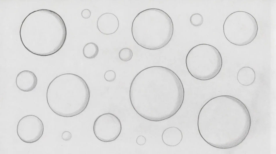 Bubbles drifting across the page