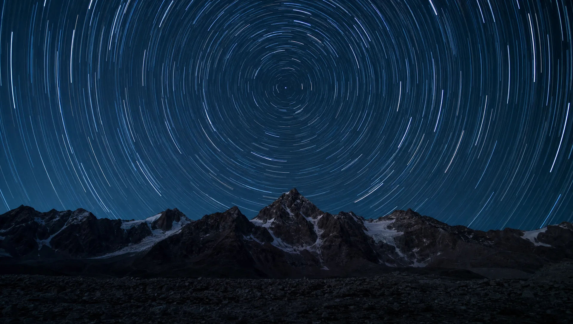 Star trails over a dark ridgeline