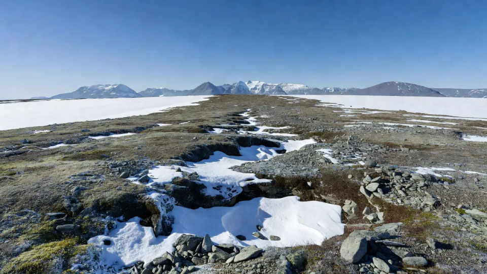 Snowline ridge under arctic sky