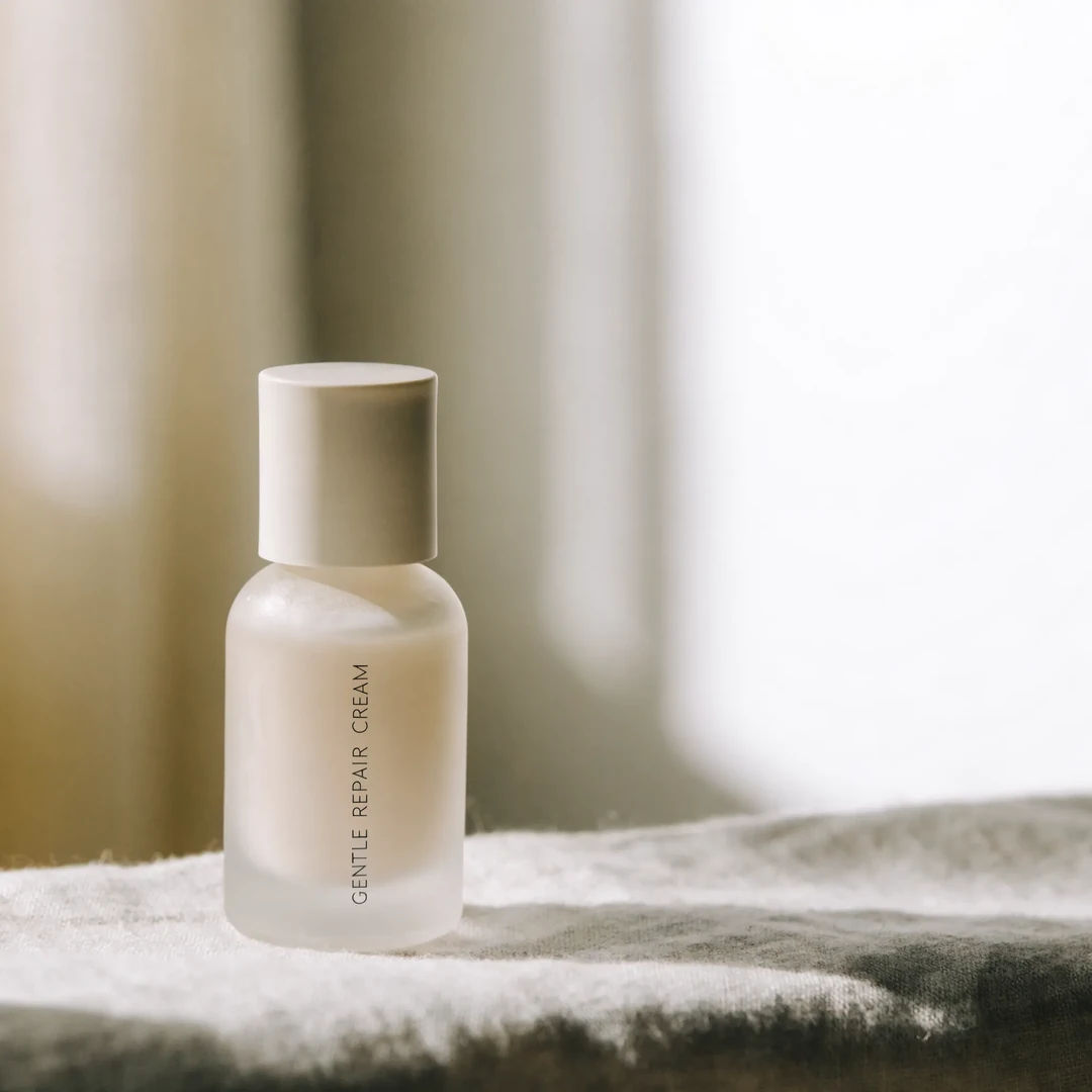 Skincare product on linen in soft daylight with negative space