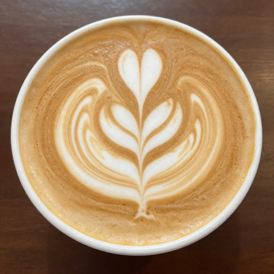Photorealistic flat white coffee shot from above with latte art