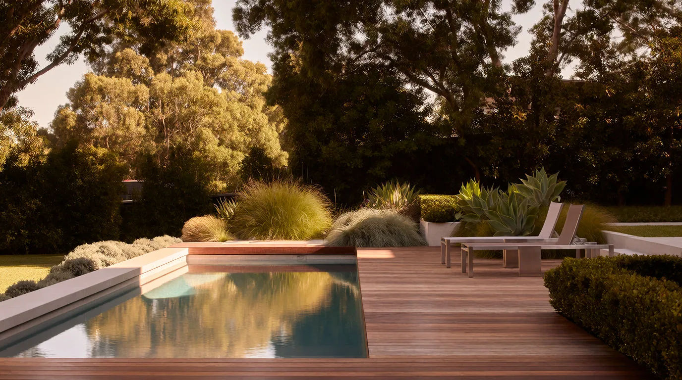 Backyard redesigned with a rectangular pool, timber deck and modern loungers