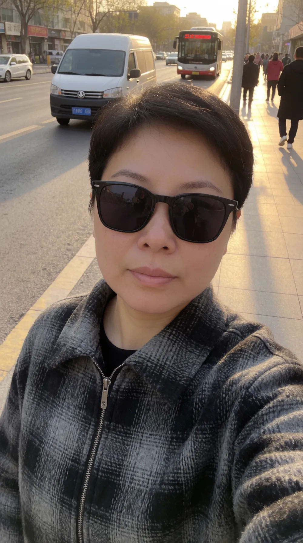 Polished outdoor selfie in golden hour light with a casual jacket on a city street