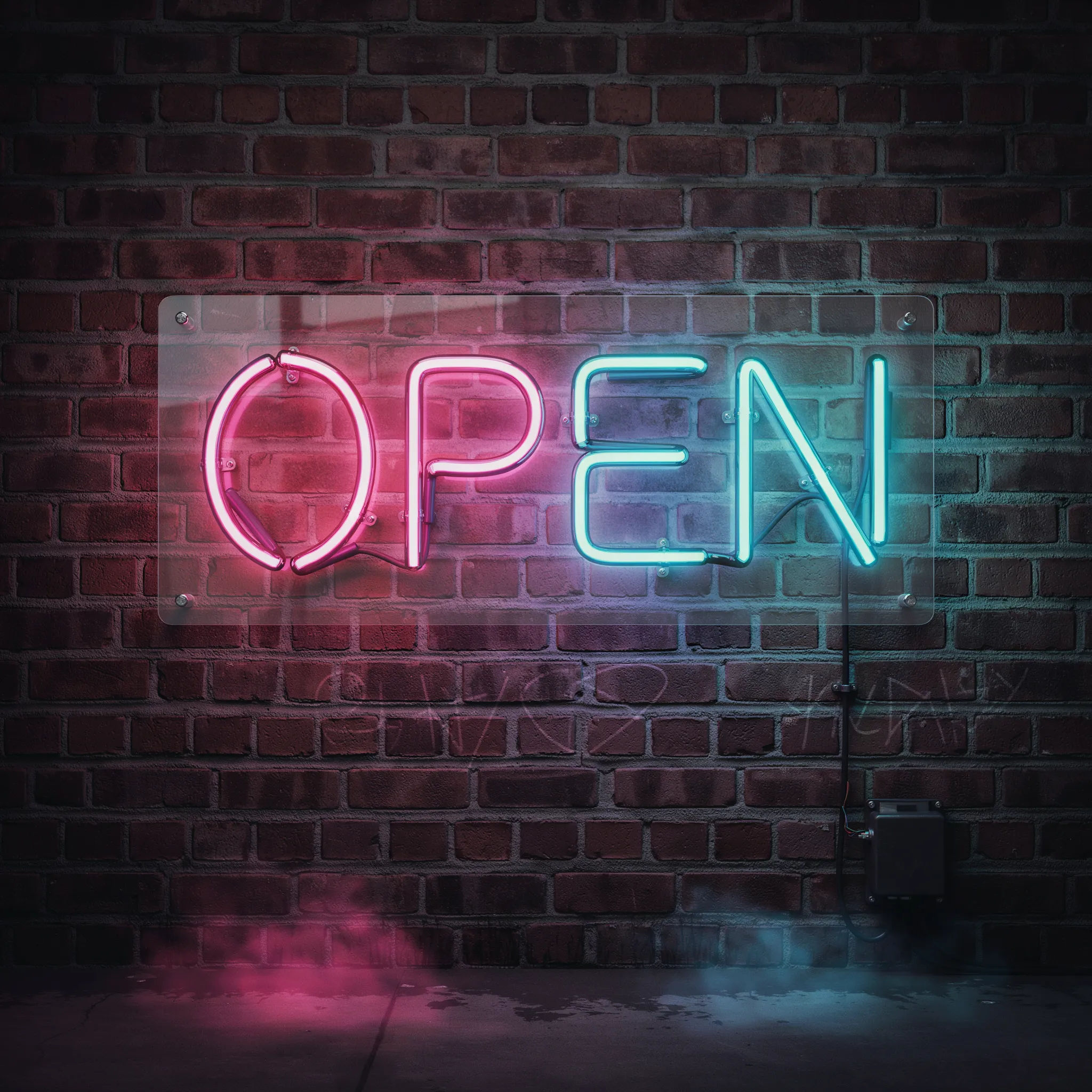 The word OPEN as glowing neon tubing on a brick wall