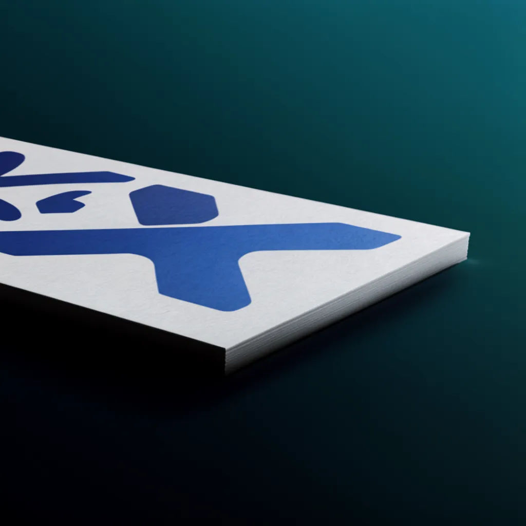Low-angle close-up of a business card showing edge and paper texture