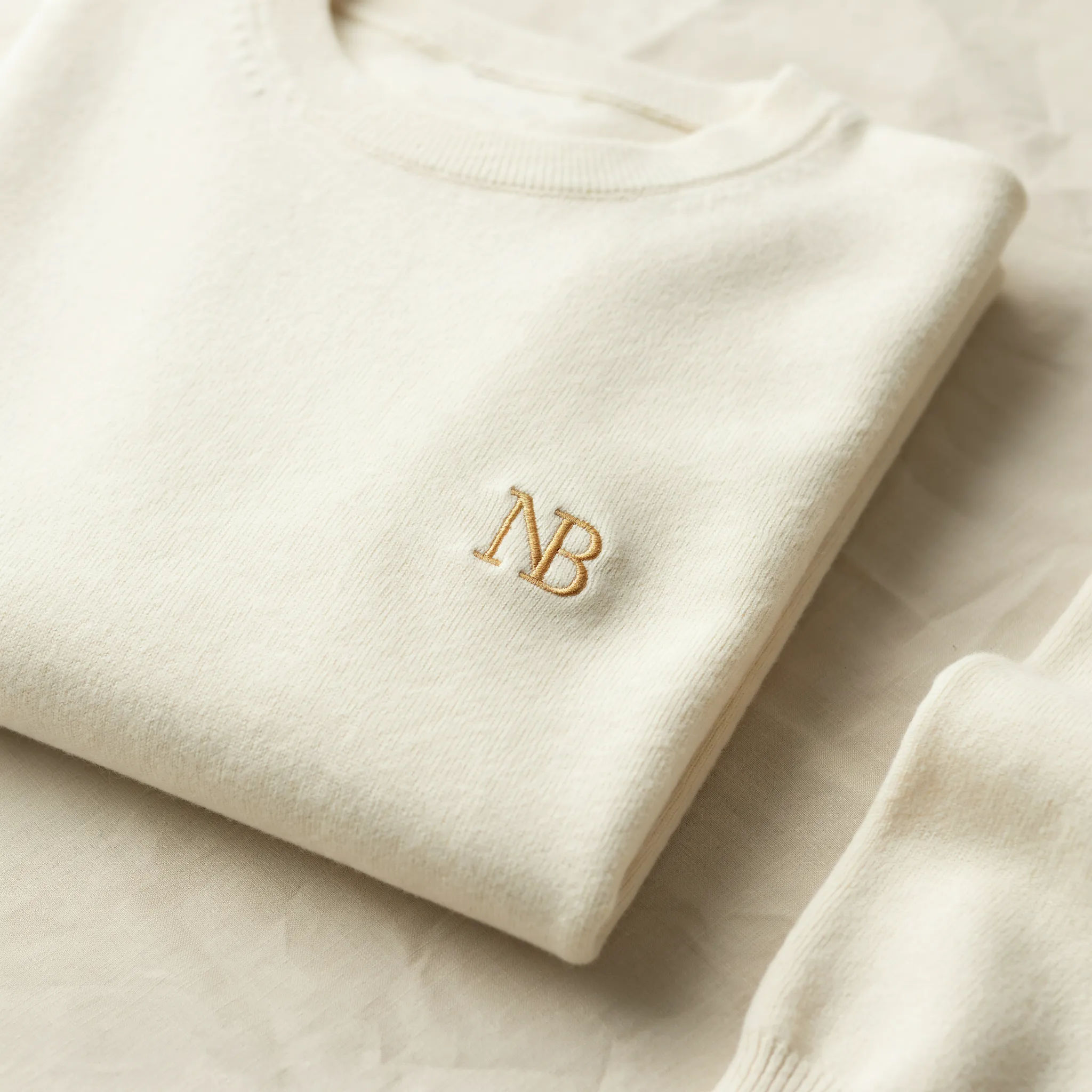 Interlocked NB monogram logo in gold