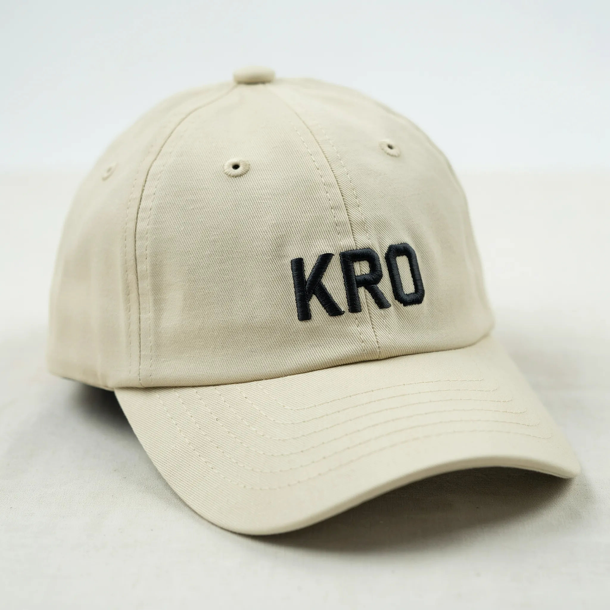 Monogram embroidered on a beige baseball cap