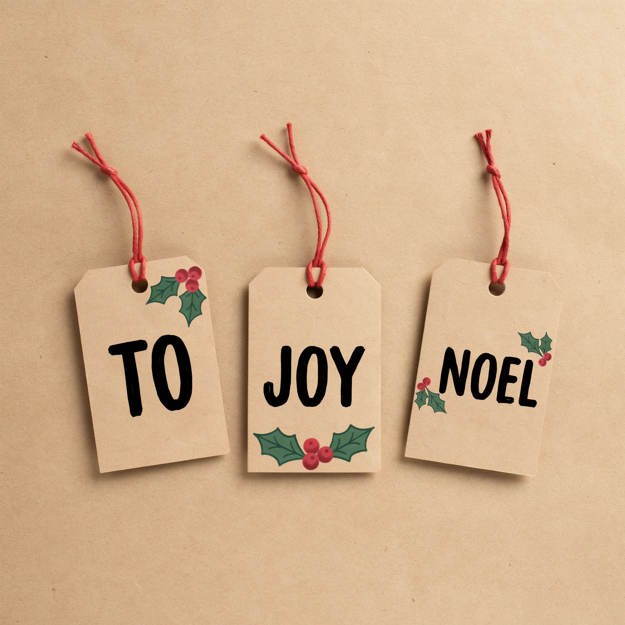 Sheet of kraft brown Christmas gift tags with red twine and bold words