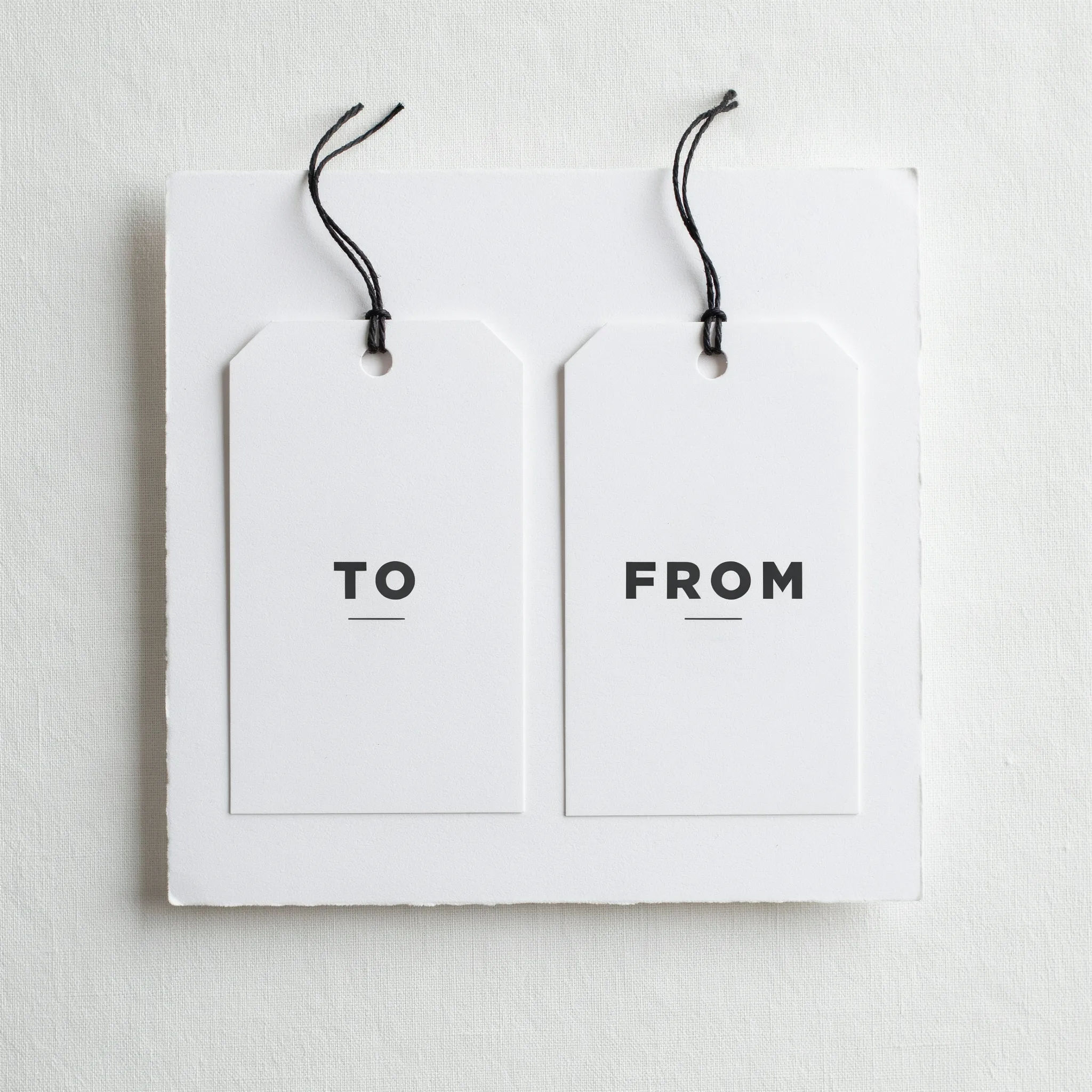 Minimalist white gift tags with clean To and From lettering