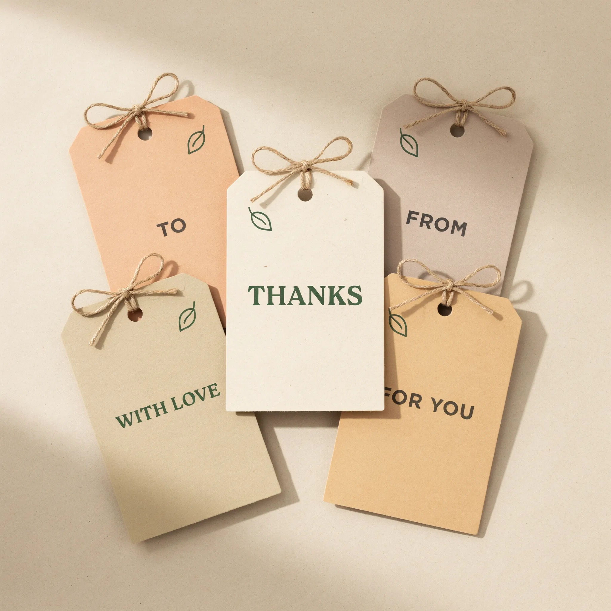 Neutral maker shop gift tags with a bold thanks and a leaf mark