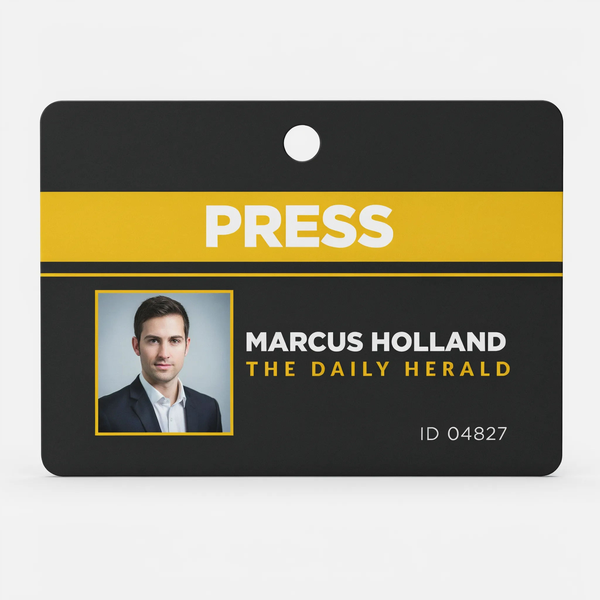 Dark press media pass with a yellow stripe and PRESS label