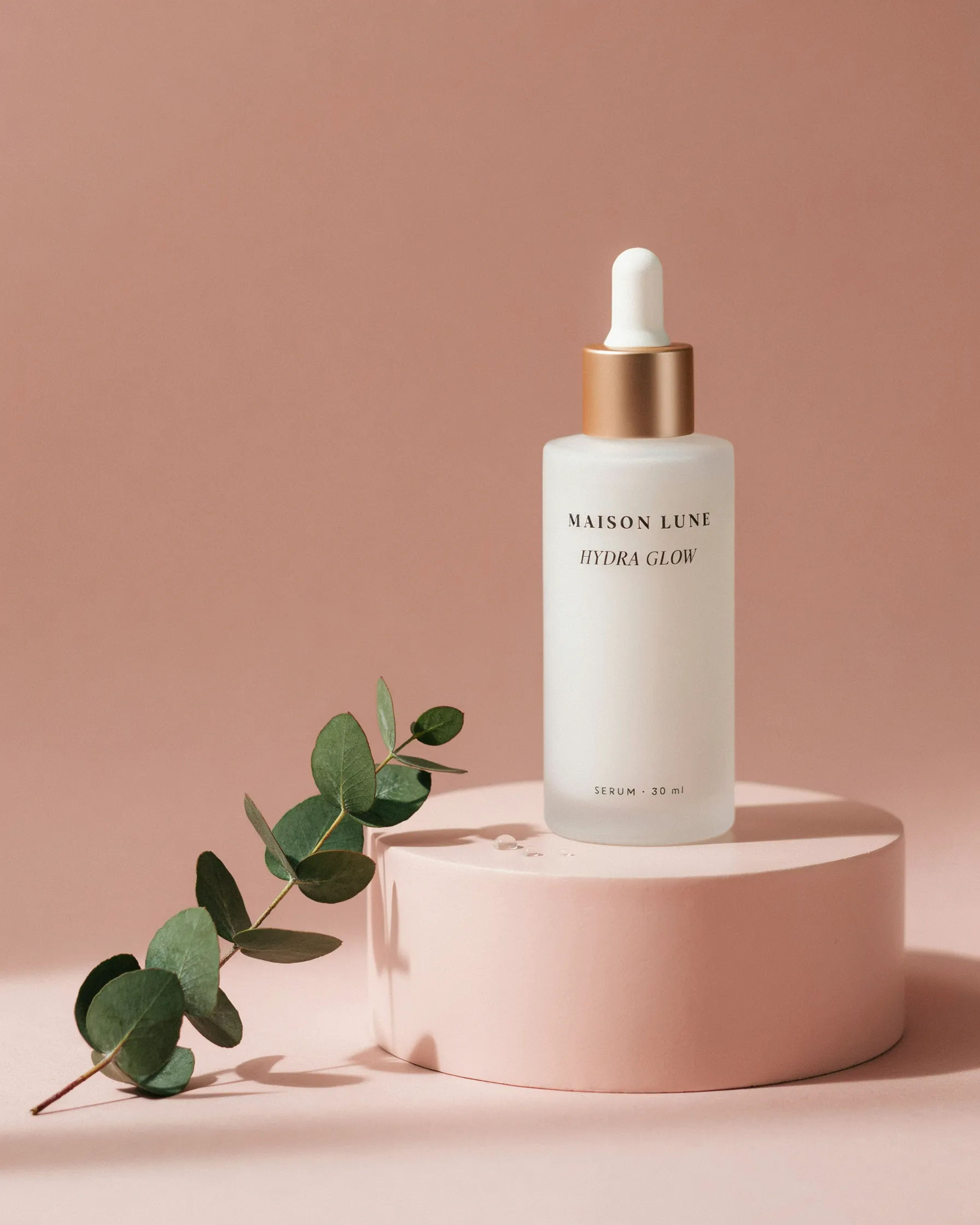 Instagram post of a skincare bottle on a pastel podium