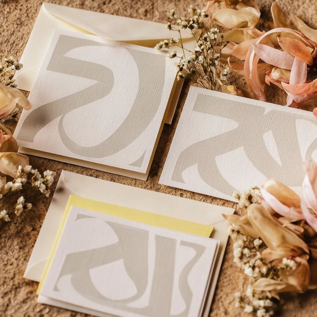 Invitation suite with RSVP and details cards laid out with florals