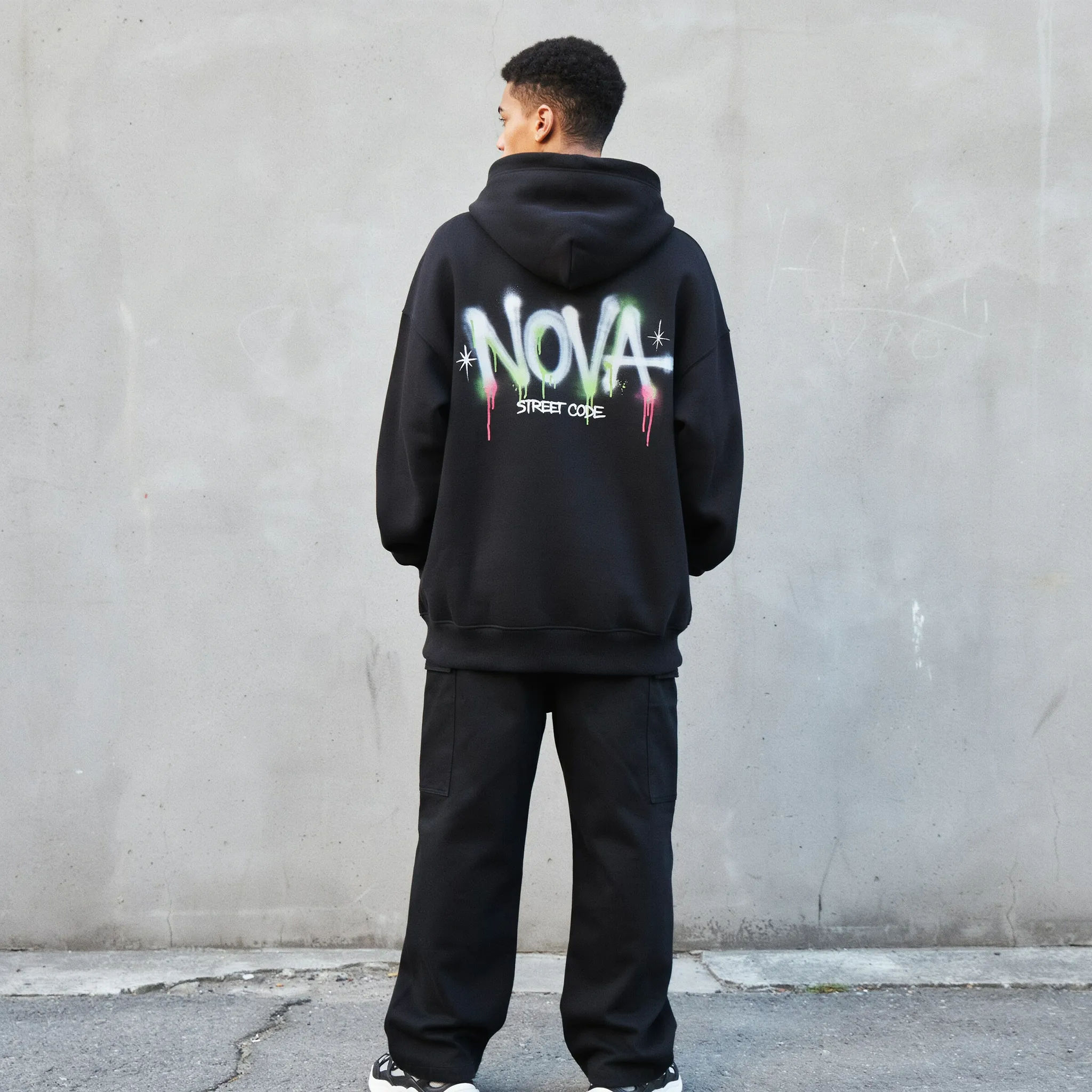 Black streetwear hoodie with a bold graffiti back print
