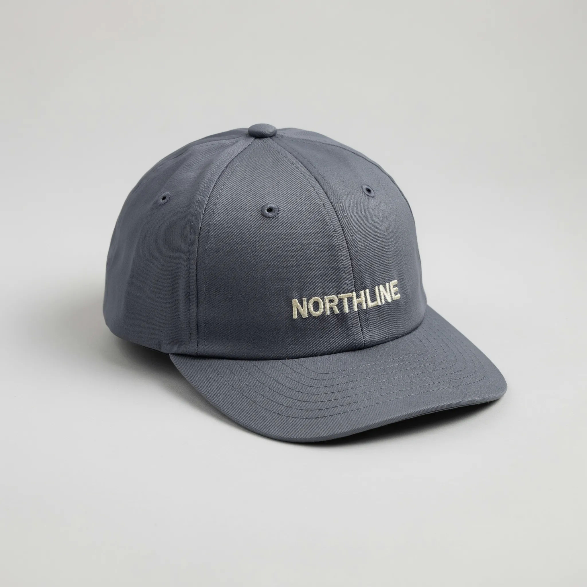 Navy snapback cap with a small embroidered wordmark
