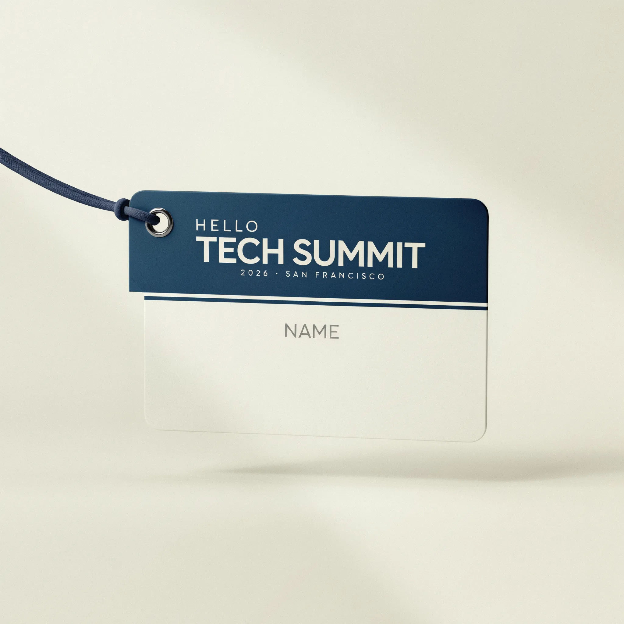 Navy and white conference name badge with a bold title and blank name field