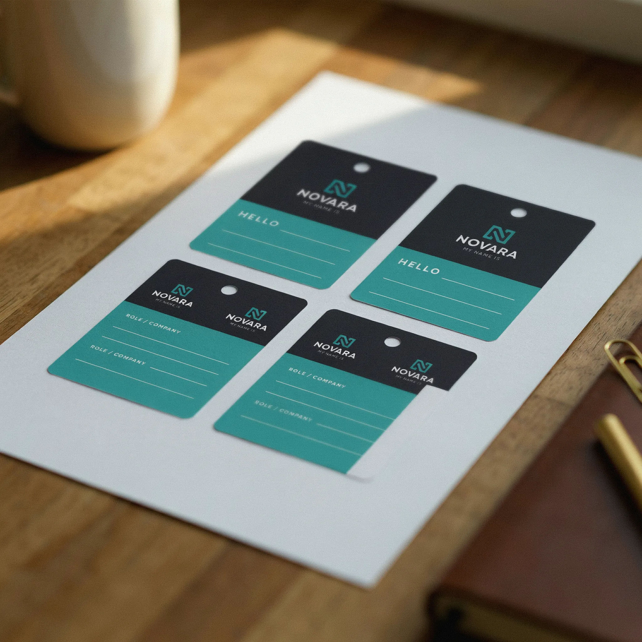 Charcoal and teal corporate badge set with a logo mark and blank name lines