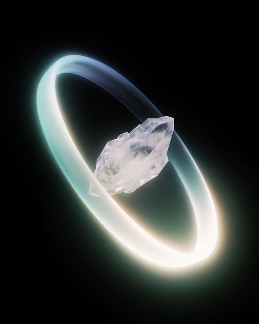 A luminous ribbon of light bent into a complete circle around a still crystal form on a black ground
