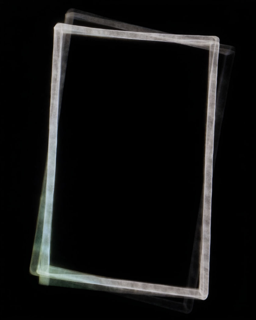 A rectangular frame of thin white light in black space on a black ground