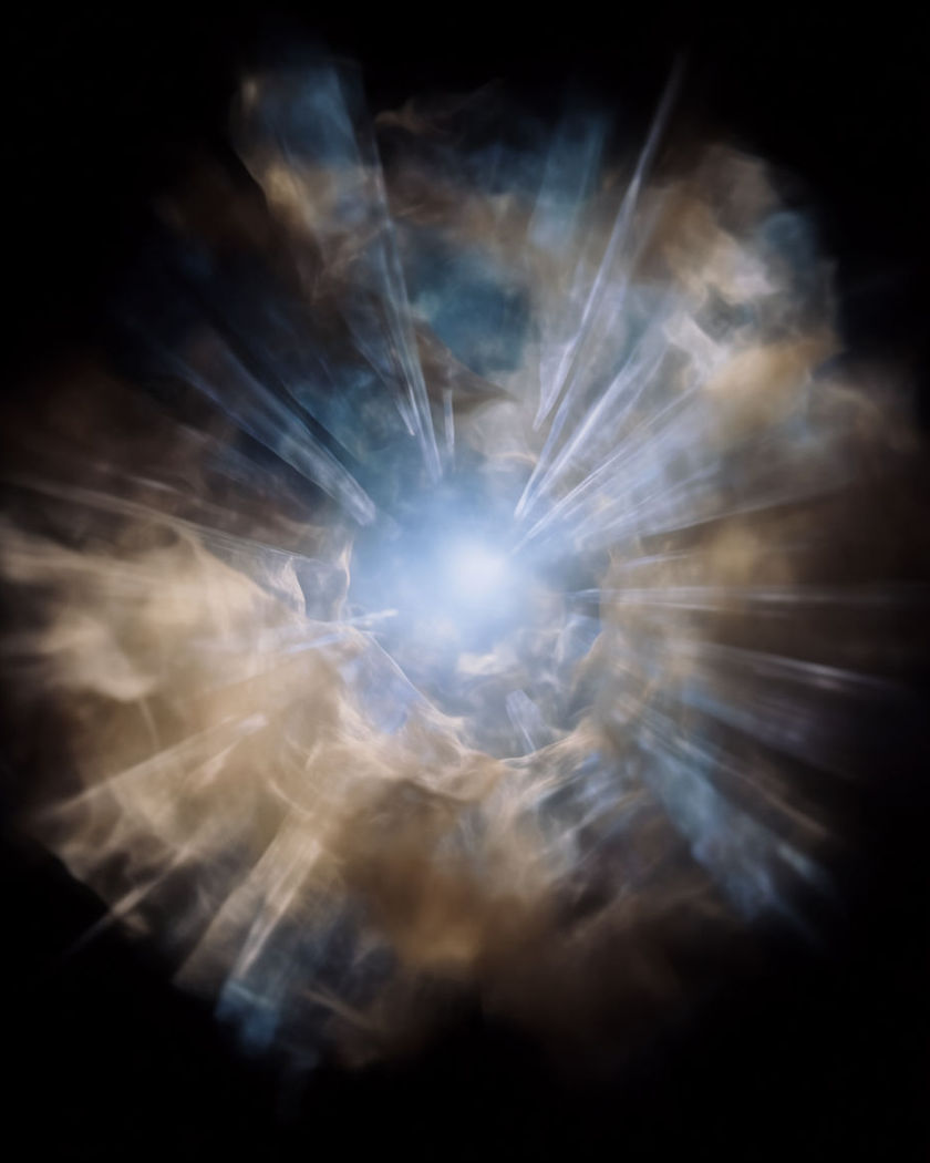 A tunnel of light rushing inward toward a bright focal point, radial streaks converging on a pure black ground