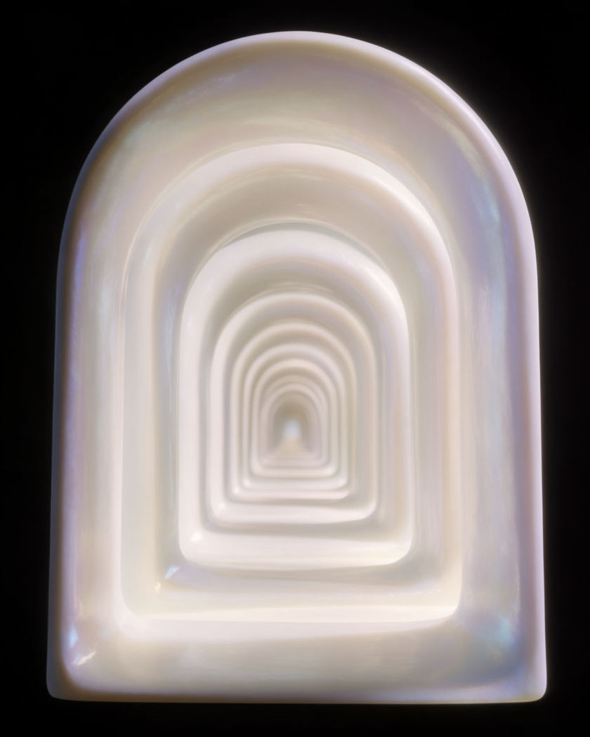 A tunnel of concentric glowing archways falling away into the distance on a black ground