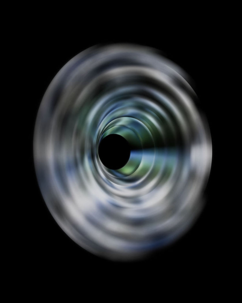 Concentric rings of soft light narrowing toward a central black disc on a black ground