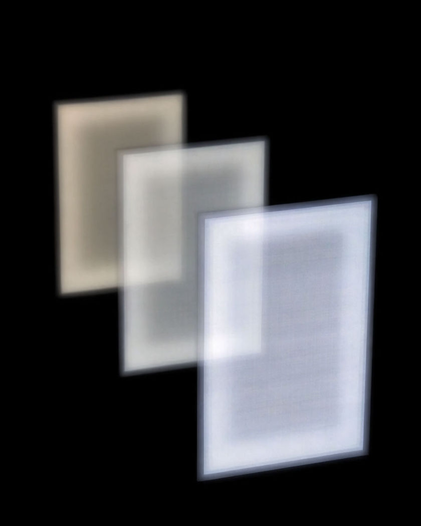 Three luminous frames receding into the distance on a black ground