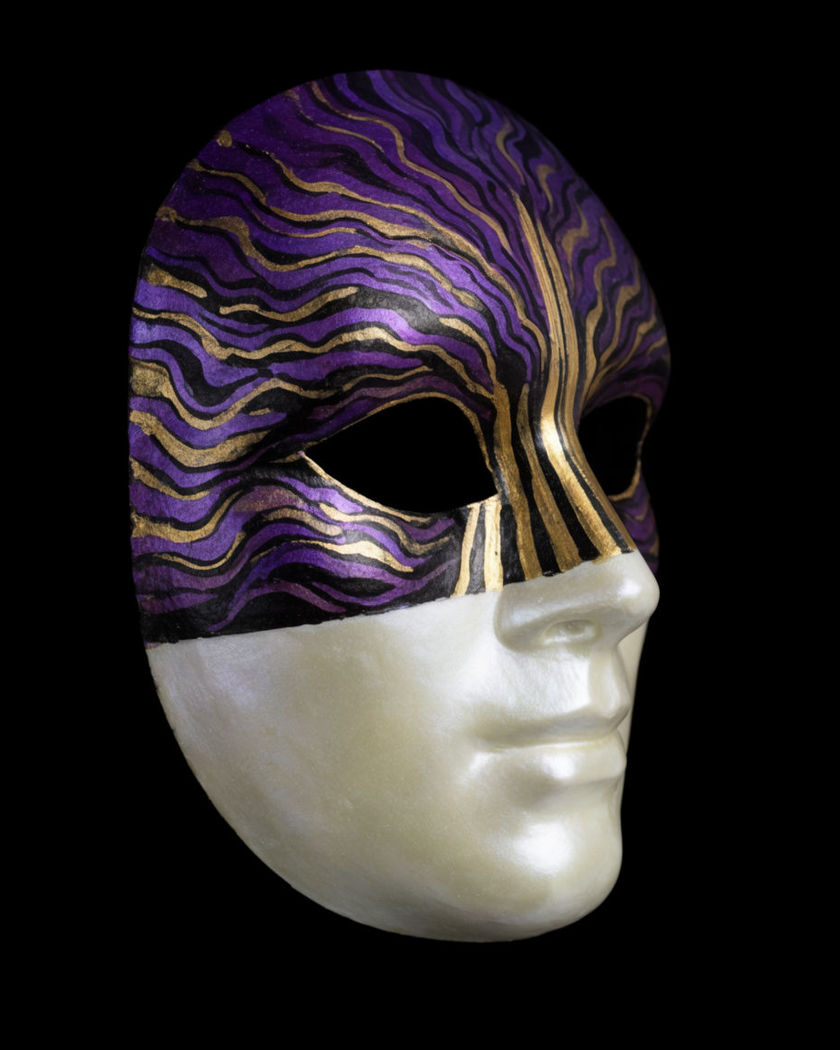 A mask shell caught halfway through painting itself on a black ground