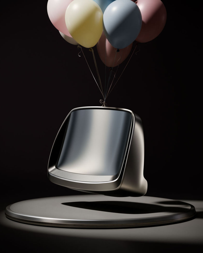 An unbranded product lifted just off a pedestal by a bunch of colourful balloons, ribbons trailing below it